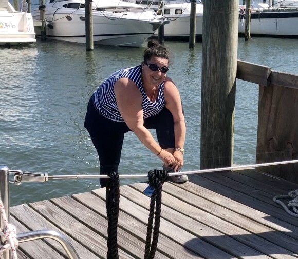 Woman on dock tying shoes